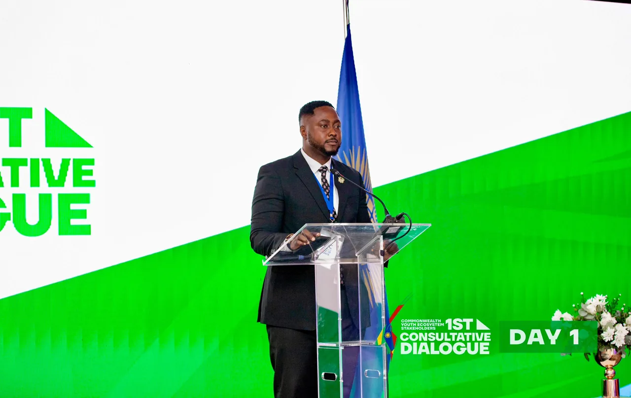 Edwin Elikem Amenyeawu speaking at a podium at the Commonwealth Youth Ecosystem Stakeholders 1st Consultative Dialogue