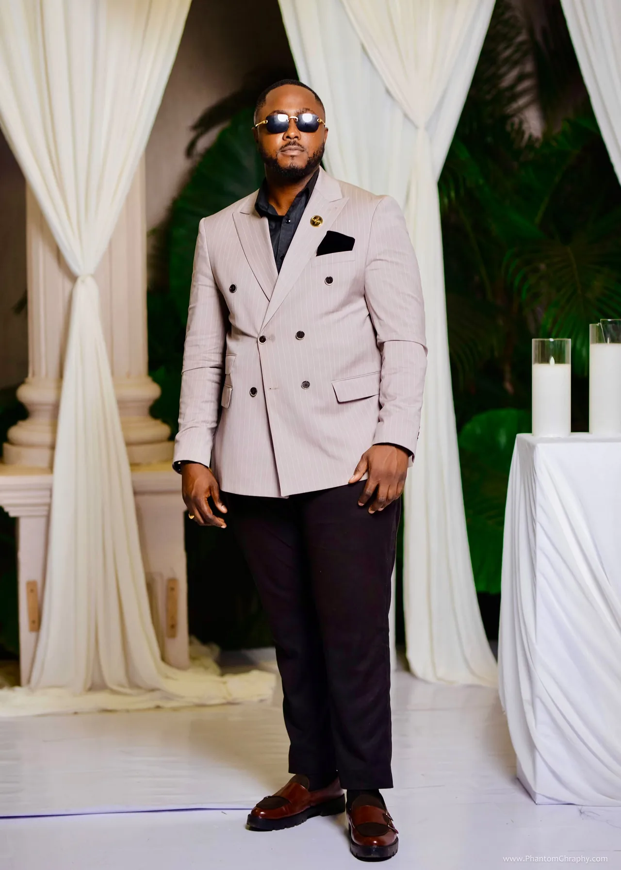 Portrait of Edwin Elikem Amenyeawu in a double-breasted pinstripe jacket